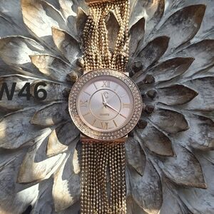 Rose gold-tone women's watch featuring a diamond-like bezel